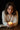 Woman holding a lit candle with a dark background