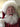 Person dressed as Santa Claus with a white beard and red suit.